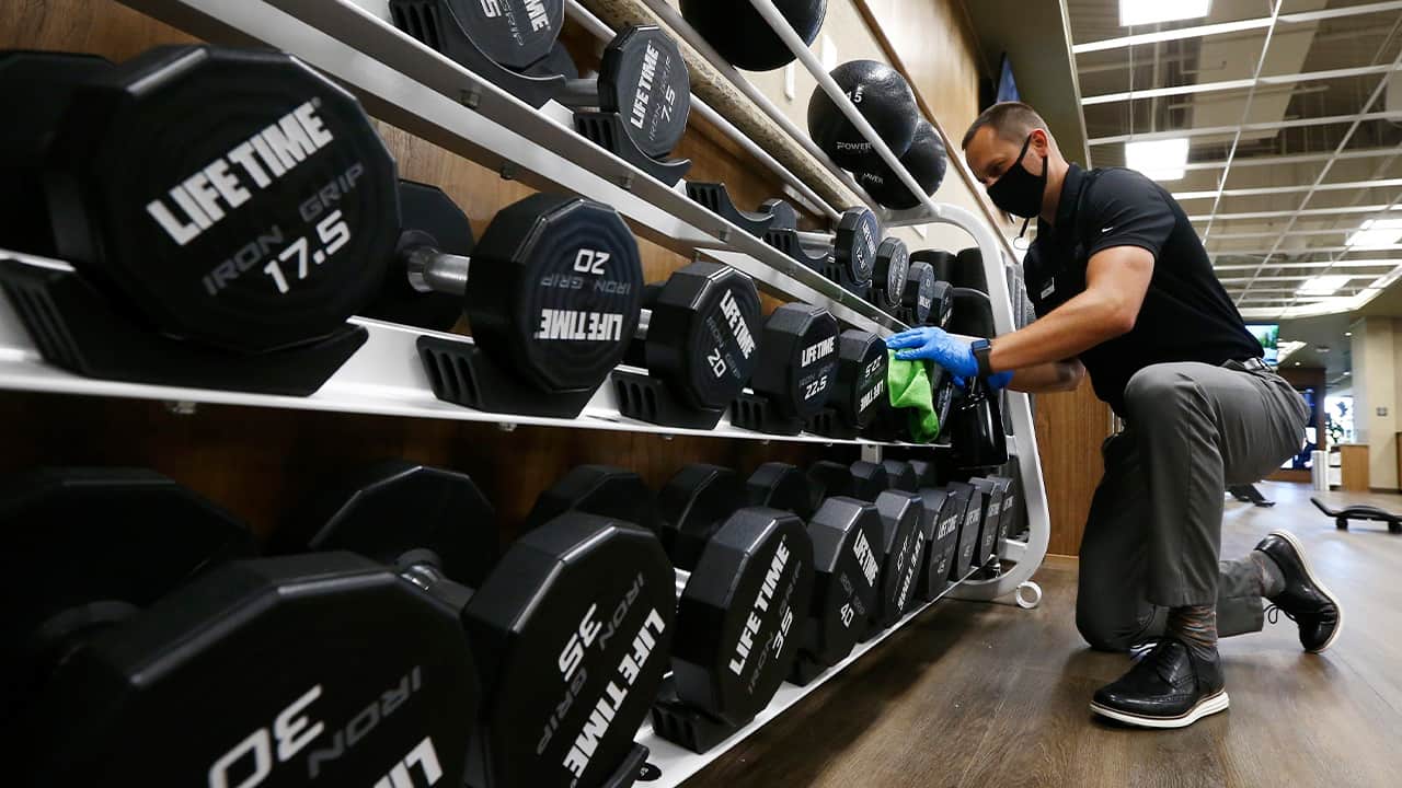 Photo of a man cleaning weights 