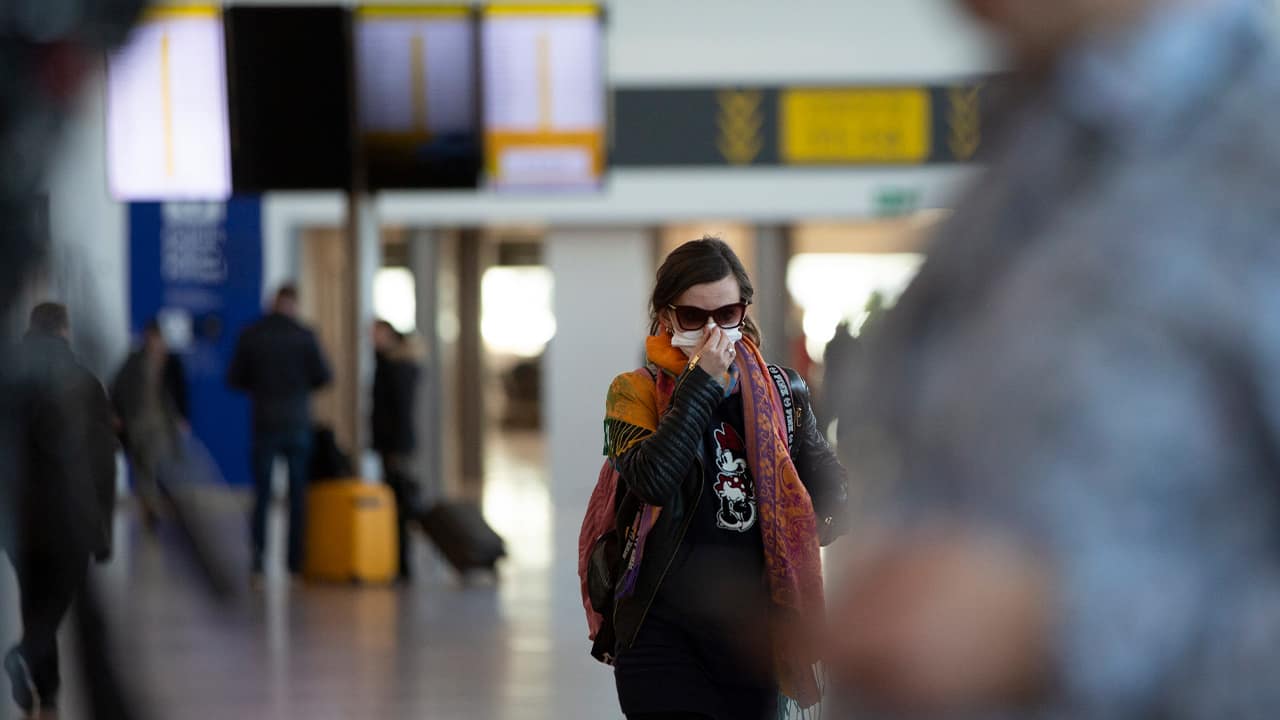 Photo of a woman wearing a mask in an airport in Brussels