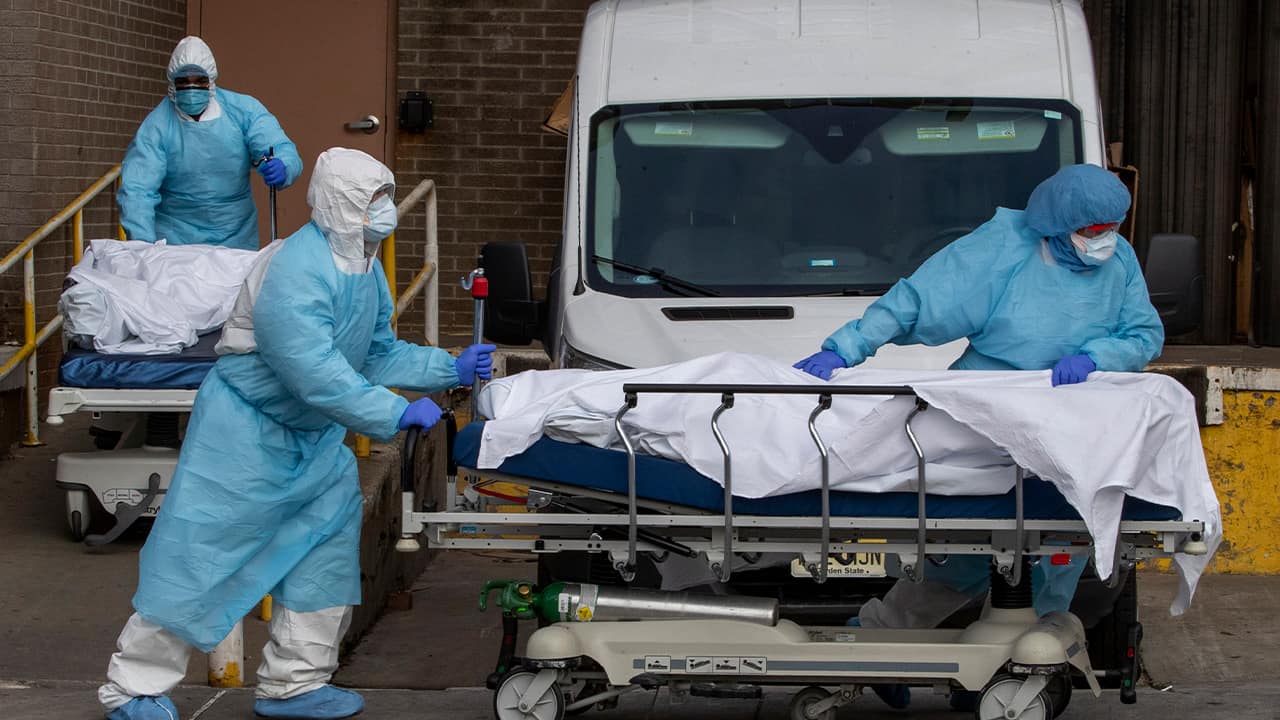Photo of health care workers removing bodies