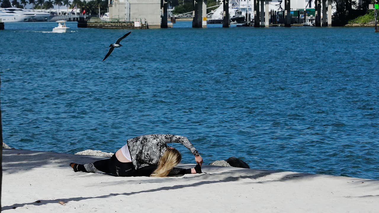 Photo of a woman working out at the beach in Miami