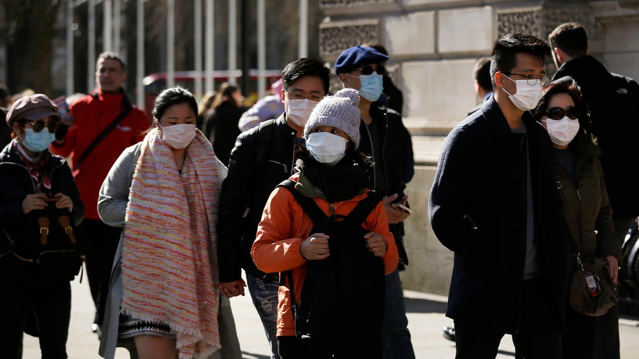 Photo of people wearing masks in London