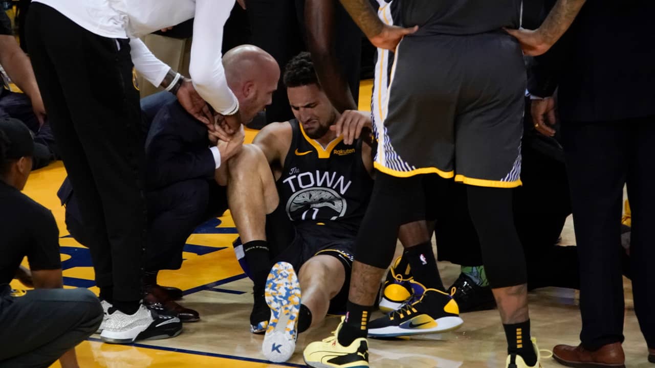 Photo of Klay Thompson being helped up after being injured