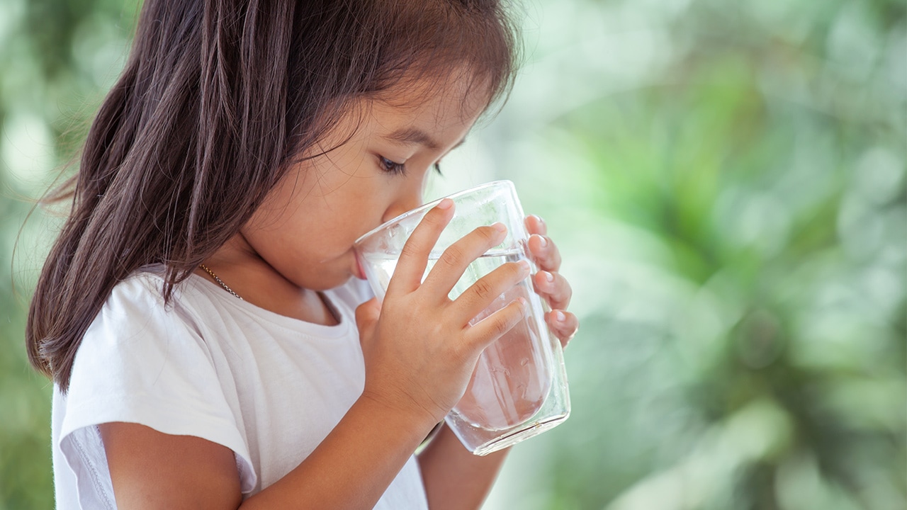 Shutterstock photo of a little girl drinking water