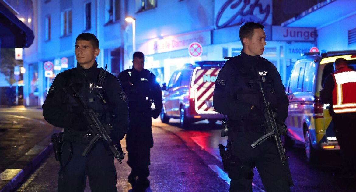 Police and ambulances near the scene where people were killed and injured in an attack at a festival in Solingen, western Germany.