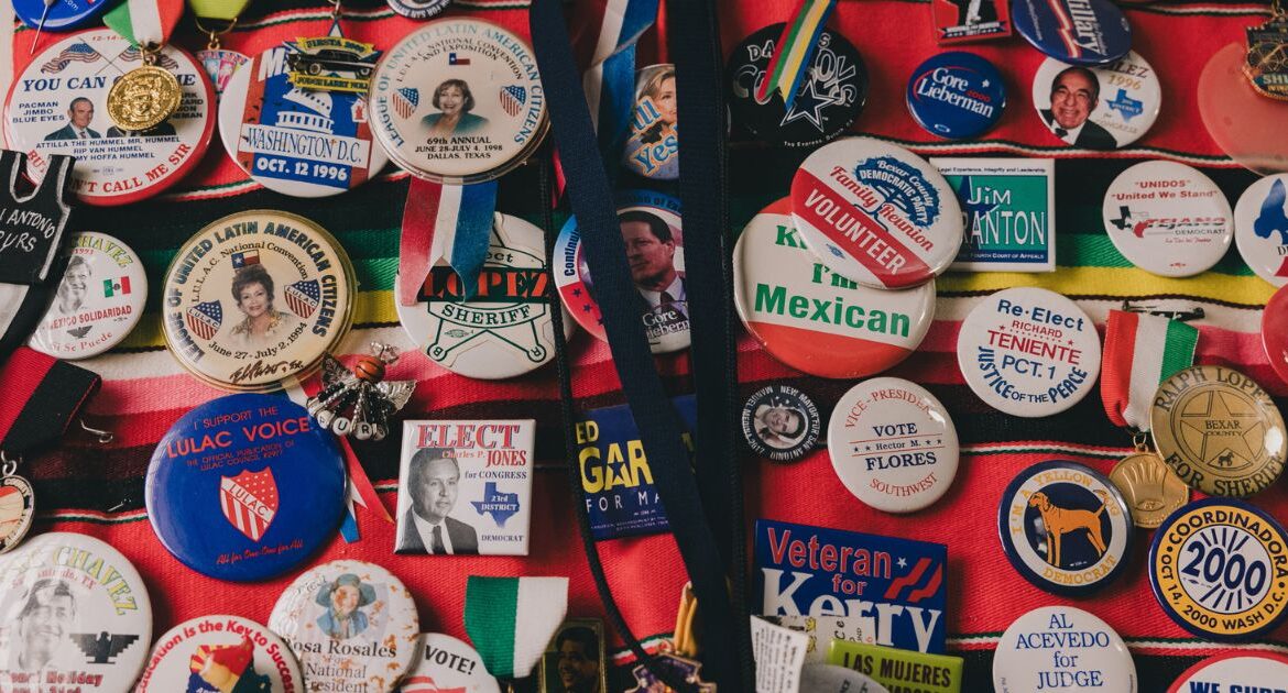Campaign pins at the home of Lidia Martinez, an 87-year-old retired educator whose home was raided on Tuesday, Aug. 20, in San Antonio, Aug. 25, 2024. A Latino civil rights group is asking the Department of Justice to open an investigation into a series of raids conducted on Latino voting activists and political operatives as part of a sprawling voter fraud inquiry by the Texas attorney general, Ken Paxton. (Christopher Lee/The New York Times)