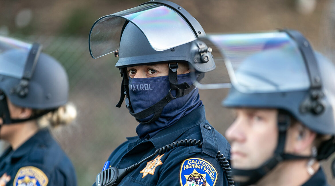Oakland, California - 6/10/20: California Highway Patrol officers guard the entrance to Interstate 580 freeway from demonstrators from the George Floyd protest.