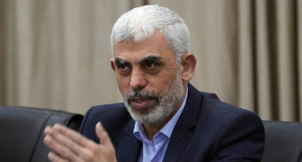 Yahya Sinwar, head of Hamas in Gaza, greets his supporters during a meeting with leaders of Palestinian factions at his office in Gaza City, Wednesday, April 13, 2022. (AP Photo/Adel Hana)