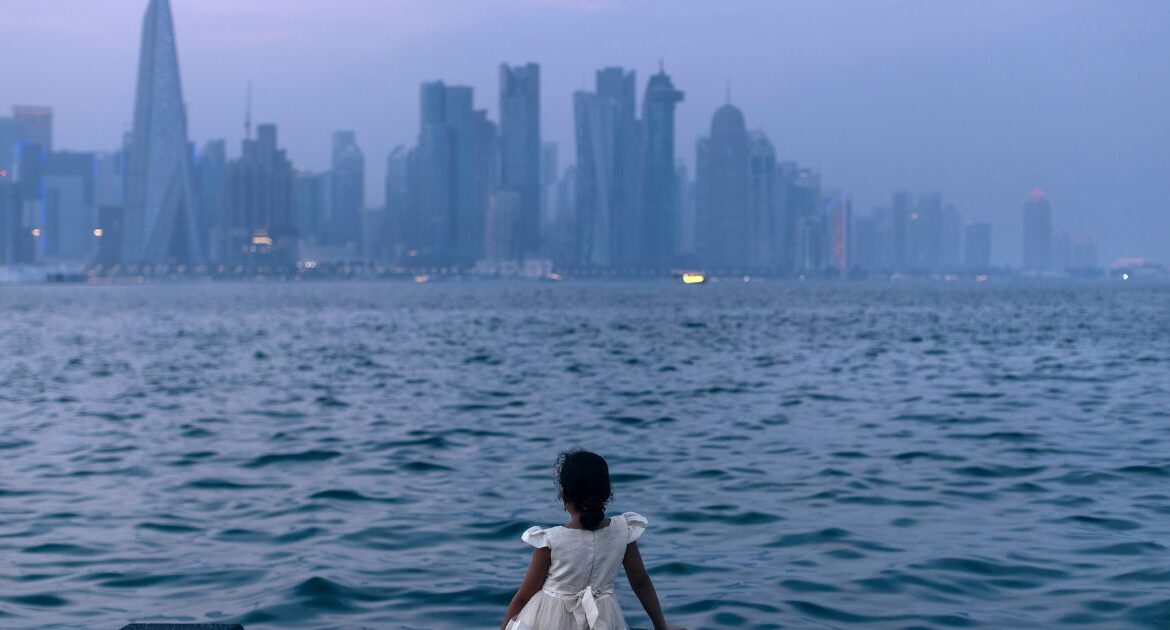 A girl watches the setting sun over Doha, Qatar’s capital, on July 10, 2024. The emirate has used its influence with Hamas to press for a truce with Israel. But “the last word is with those on the battlefield,” one expert said. (Diego Ibarra Sanchez/The New York Times)