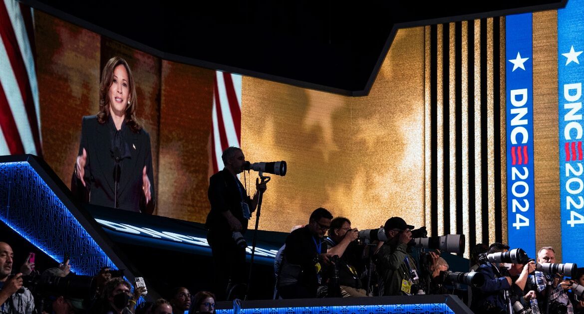 Vice President Kamala Harris, the Democratic presidential nominee, is displayed above reporters as she speaks at the Democratic National Convention in Chicago, Aug. 22, 2024. The vice president, who has granted few interviews as the Democratic nominee, is now ramping things up. But she is likely to focus on local outlets and nontraditional venues where voters get their news. (Haiyun Jiang/The New York Times)