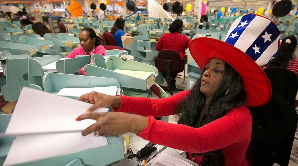 Workers sort income tax returns at the Franchise Tax Board in Sacramento on April 18, 2017. Some political leaders want to remove the $10,000 cap on how much local and state taxes people can deduct on federal tax returns. (AP/Rich Pedroncelli)
