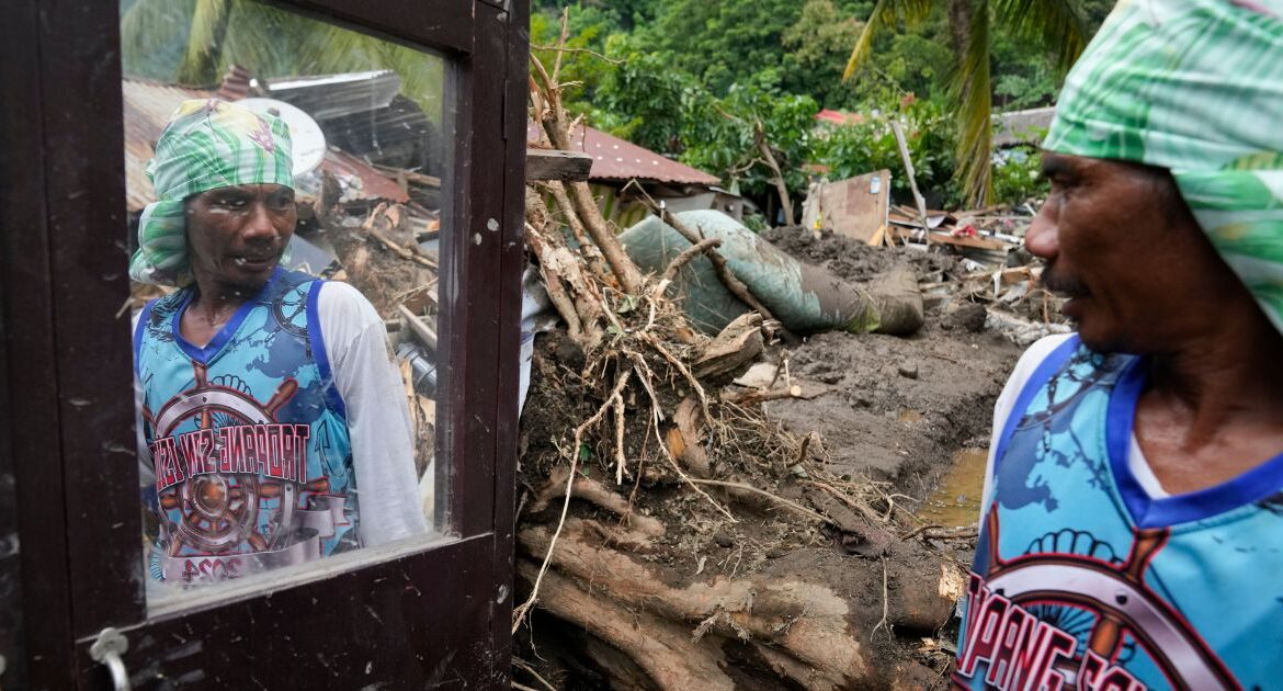 Marcelino Aringo speaks near his damaged house after a landslide triggered by Tropical Storm Trami struck homes, leaving several villagers dead in Talisay, Batangas province, Philippines on Saturday, Oct. 26, 2024. (AP/Aaron Favila)