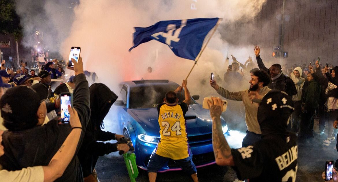 Fans celebrate on the streets after the Los Angeles Dodgers won against the New York Yankees in the baseball World Series Wednesday, Oct. 30, 2024, in downtown Los Angeles. (AP/Damian Dovarganes)
