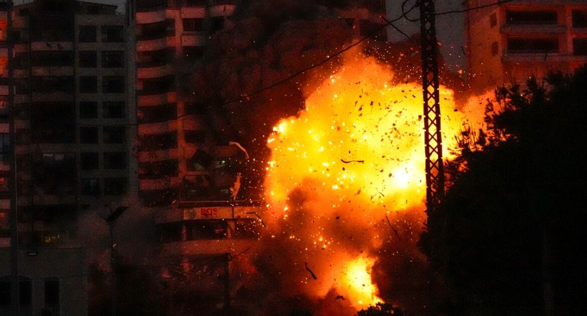 Thick smoke, flames and debris erupt from an Israeli airstrike that targeted a building in Tayouneh, Beirut, Lebanon, Monday, Nov. 25, 2024. (AP/Hassan Ammar)