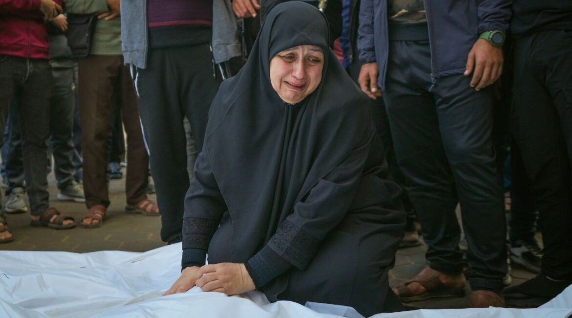 Asma Al Habash, mourns her brother and his family, victims of an Israeli army strike on the Nuseirat refugee camp, at the Al-Aqsa Martyrs hospital in Deir al-Balah, Gaza Strip, Thursday Dec. 12, 2024. Palestinian medical officials say Israeli airstrikes have killed at least 28 people in the Gaza Strip, including seven children and a woman. (AP Photo/Abdel Kareem Hana)