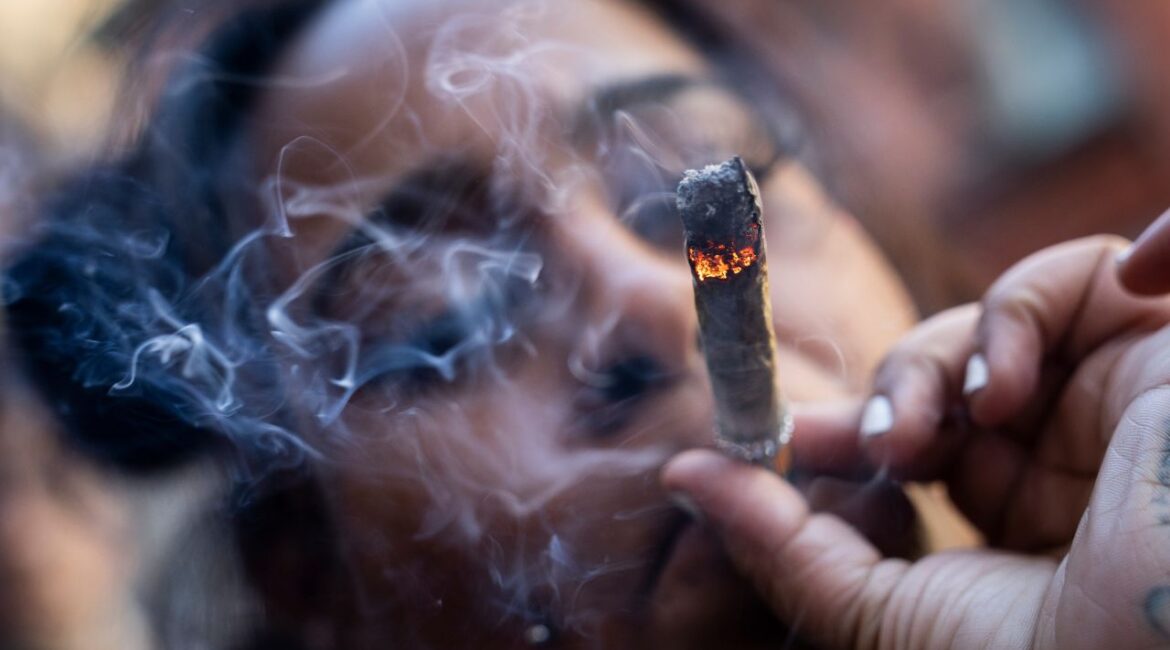A person smokes cannabis outside the Smacked "pop up" cannabis dispensary location, Tuesday, Jan. 24, 2023, in New York. (AP File)