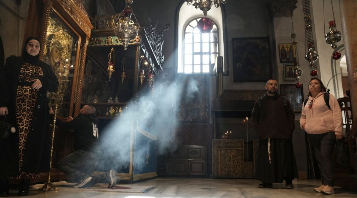 Worshippers visit the Church of the Nativity, where Christians believe Jesus Christ was born, ahead of Christmas in the West Bank city of Bethlehem, Tuesday, Dec. 17, 2024. (AP/Mahmoud Illean)