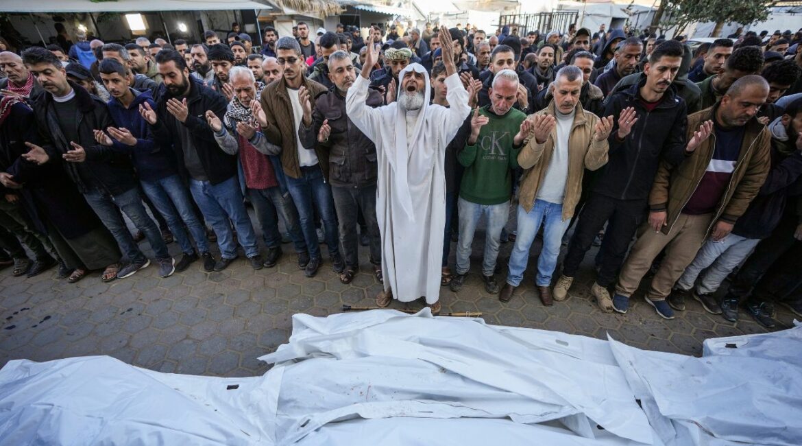 Palestinians pray over the bodies of the victims of an Israeli strike on a home late Saturday before the funeral outside the Al-Aqsa Martyrs Hospital in Deir al-Balah Sunday, Dec. 22, 2024. At least eight people were killed according to the hospital which received the bodies.(AP/Abdel Kareem Hana)