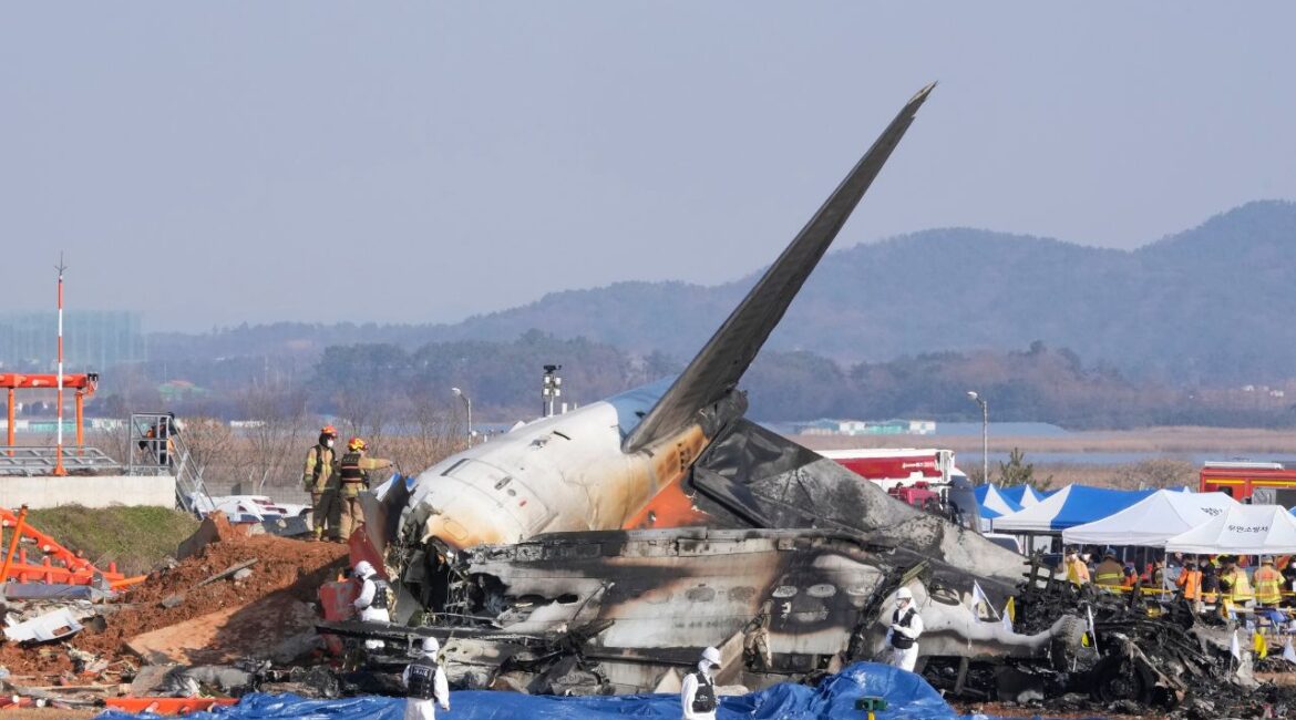 Firefighters and rescue team members work near the wreckage of a passenger plane at Muan International Airport in Muan, South Korea, Sunday, Dec. 29, 2024. (AP/Ahn Young-joon)