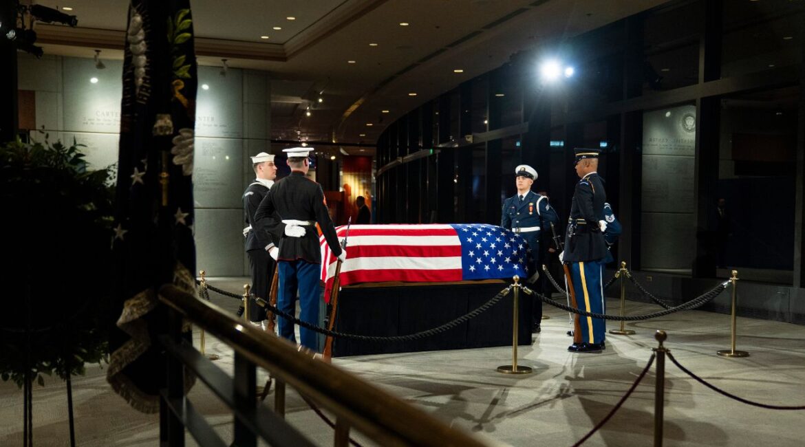 The joint services military honor guard stand around the casket of former President Jimmy Carter as he lies in repose at the Jimmy Carter Presidential Library and Museum in Atlanta, Tuesday, Jan. 7, 2025. Carter died Dec. 29 at the age of 100. (AP/Alex Brandon)