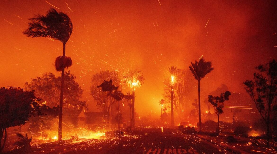 The Palisades Fire ravages a neighborhood amid high winds in the Pacific Palisades neighborhood of Los Angeles, Tuesday, Jan. 7, 2025. (AP Photo/Ethan Swope)