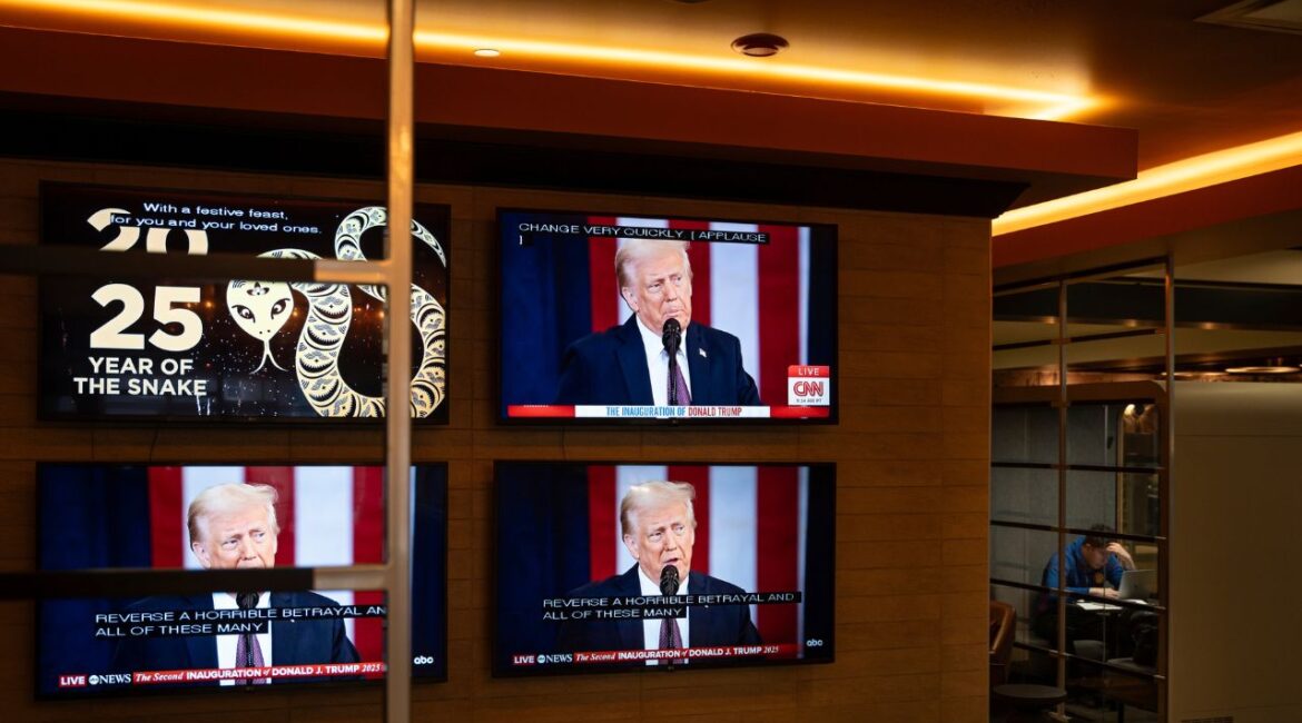 The inauguration of U.S. President Donald Trump plays live on screens in the lobby of a building in Halifax, Nova Scotia, on Monday, Jan. 20, 2025. (Darren Calabrese/The Canadian Press via AP)
