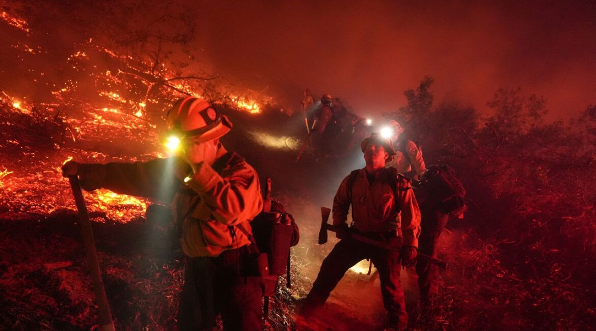 Firefighters battle the Lilac Fire in Bonsall, Calif., Tuesday, Jan. 21, 2025. (AP Photo/Jae C. Hong)