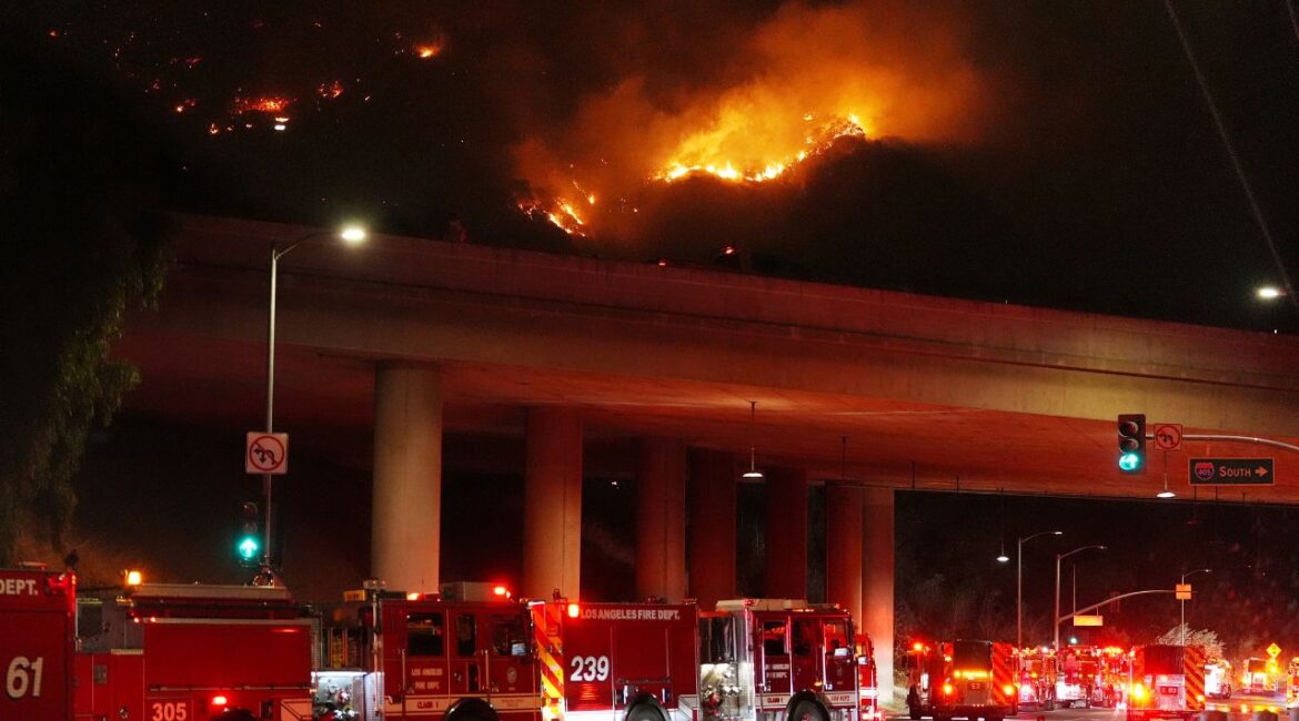 Apparatus sits on Sepulveda Blvd. as fire burns along Interstate 405, Thursday, Jan. 23, 2025, in Los Angeles. (AP/Mark J. Terrill)