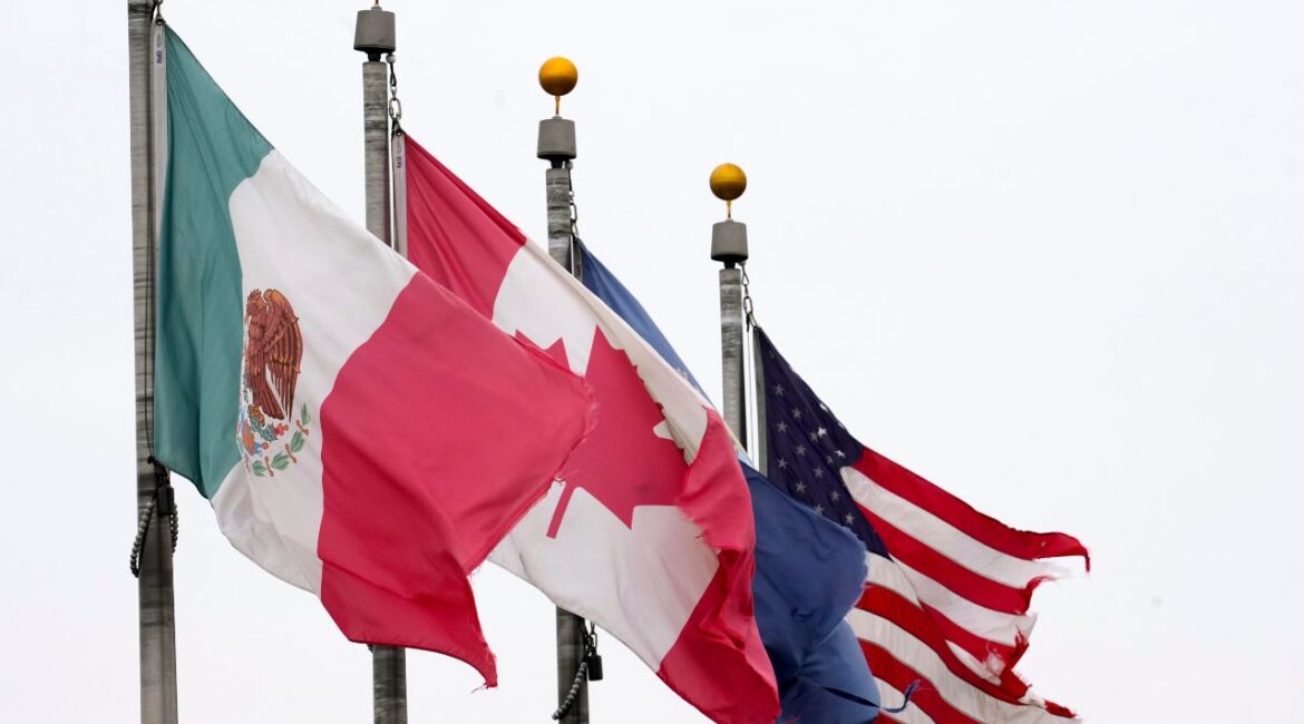 The flags of Mexico, Canada and the United States are shown near the Ambassador Bridge, Monday, Feb. 3, 2025, in Detroit. (AP/Paul Sancya)