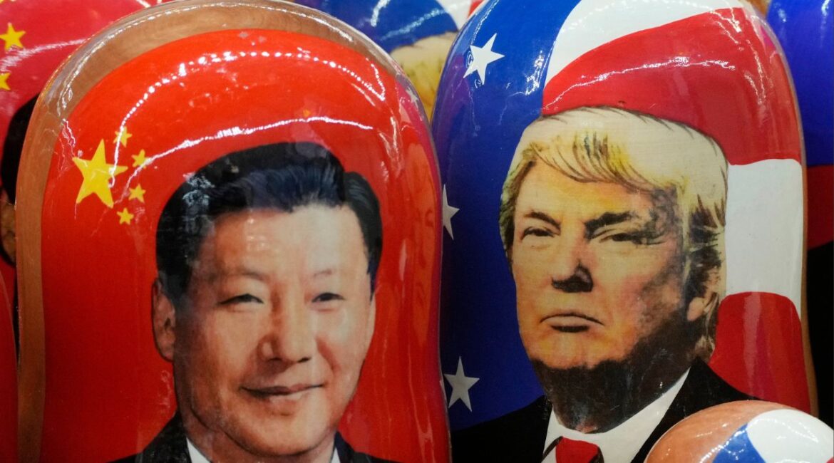 Traditional Russian wooden dolls called Matryoshka depicting China's President Xi Jinping, left, and U.S. President Donald Trump are on sale at a souvenir shop in St. Petersburg, Russia, on Nov. 21, 2024. (AP File)