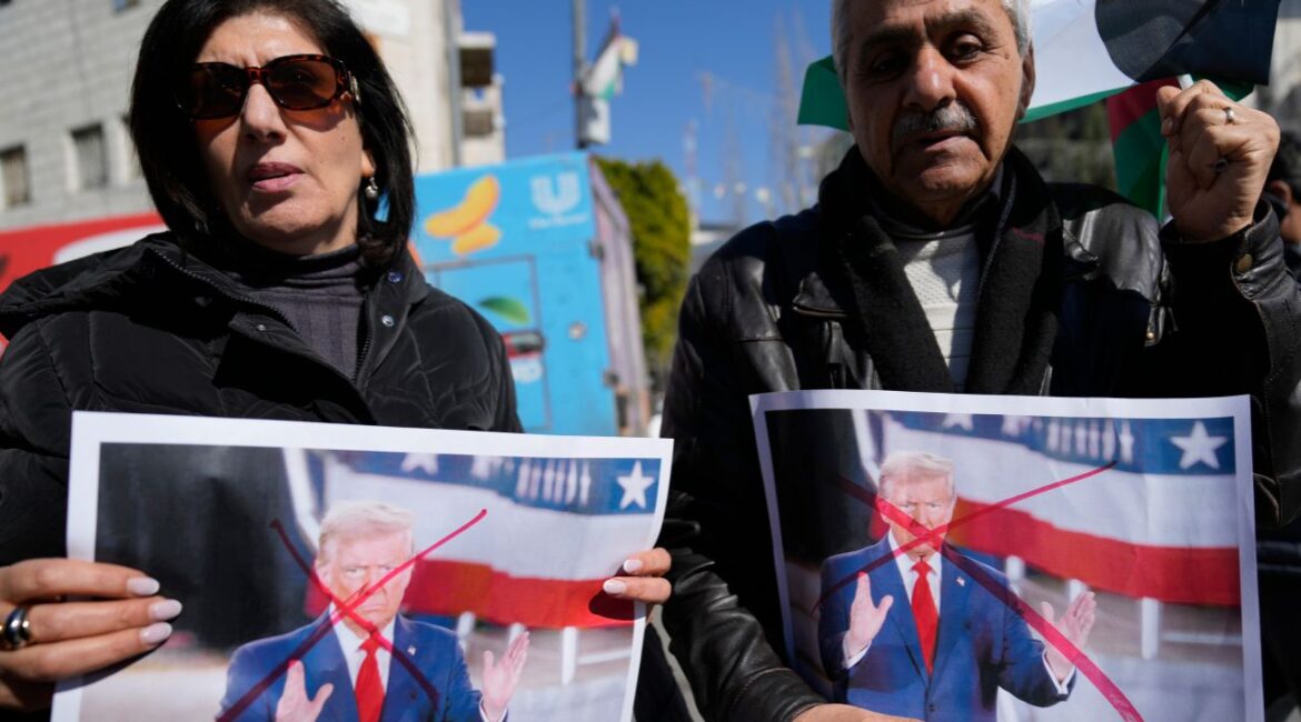 Palestinians carry defaced pictures of U.S. President Donald Trump while protesting against his latest statements regarding the transfer of Palestinians from Gaza, in the West Bank city of Ramallah Wednesday, Jan. 29, 2025. (AP/Nasser Nasser)
