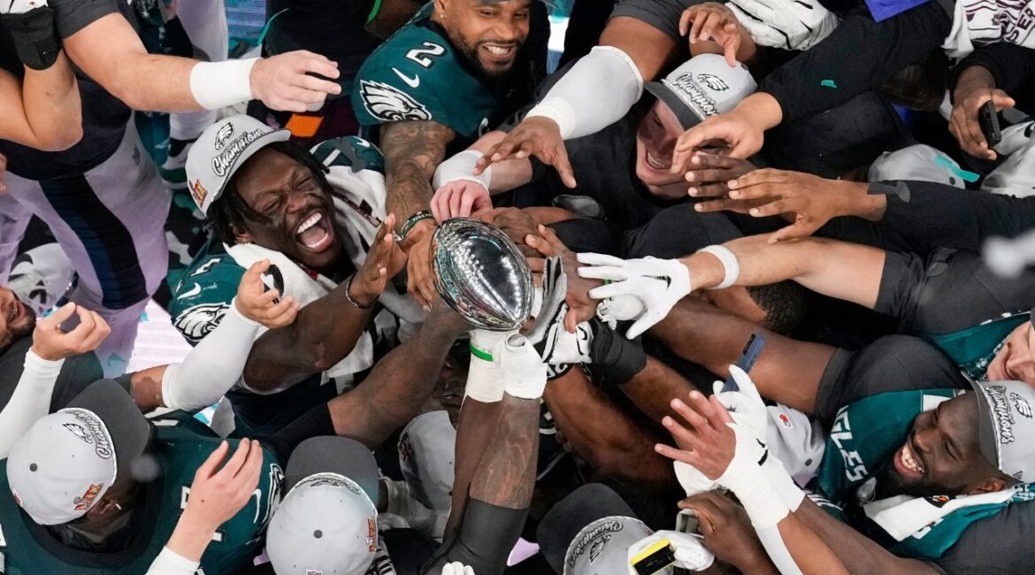 Philadelphia Eagles players celebrate with the Vince Lombardi Trophy after the Eagles won the NFL Super Bowl 59 football game against the Kansas City Chiefs, Sunday, Feb. 9, 2025, in New Orleans. (AP Photo/David J. Phillip)