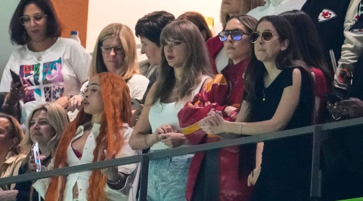 Ice Spice, from left, Taylor Swift, Este Haim and Alana Haim watch during the first half of the NFL Super Bowl 59 football game between the Kansas City Chiefs and the Philadelphia Eagles, Sunday, Feb. 9, 2025, in New Orleans. (AP Photo/Gerald Herbert)
