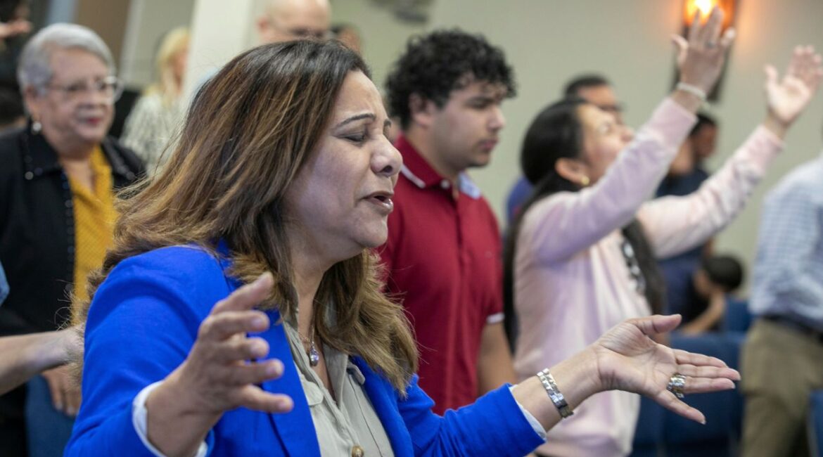 Fatima Guzman prays during a church service at the Centro Cristiano El Pan de Vida, a mid-size Church of God of Prophecy congregation in Kissimmee, Florida, Sunday, Feb. 2, 2025. (AP Photo/Alan Youngblood)