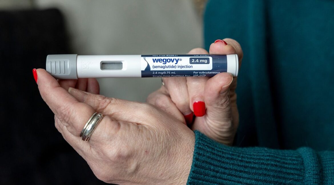 A woman holds up a dosage of Wegovy, a drug used for weight loss, at her home in Front Royal, Va., on March 1, 2024. (AP File)