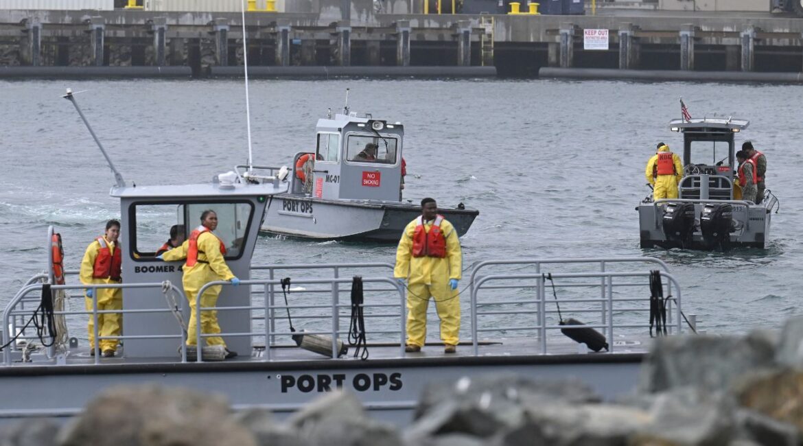U.S. Navy boats work along the shore near Shelter Island after a U.S. Navy plane crashed into the San Diego Bay, Wednesday, Feb. 12, 2025, in San Diego. (AP/Denis Poroy)