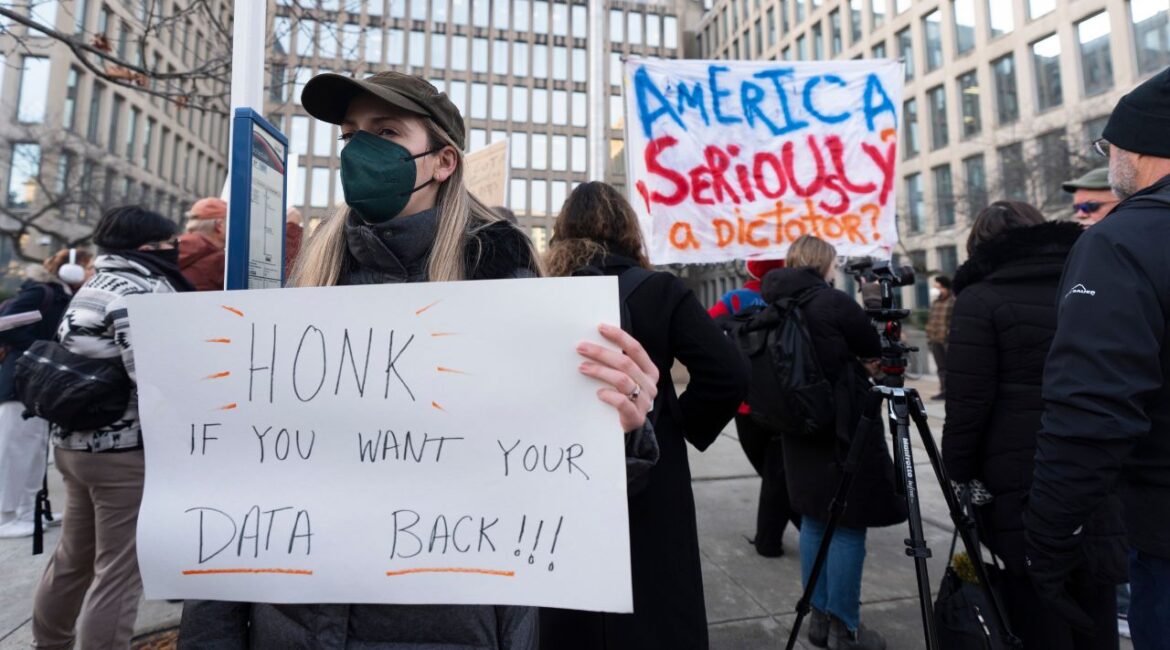 Protesters hold banners during a rally in front of the Office of Personnel Management, Monday, Feb. 3, 2025, in Washington. President Donald Trump is relying on a relatively obscure federal agency to reshape government. The Office of Personnel Management was created in 1979 by President Jimmy Carter and is the equivalent of the government's human resources department. (AP/Manuel Balce Ceneta)