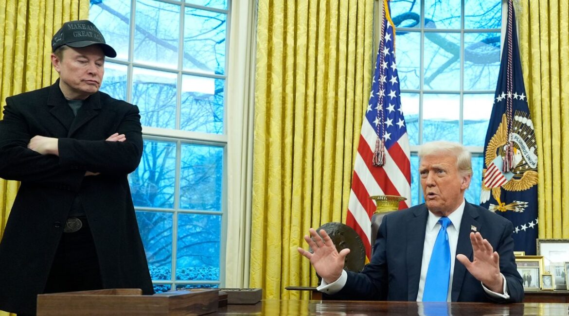 President Donald Trump speaks with reporters as Elon Musk listens in the Oval Office at the White House, Tuesday, Feb. 11, 2025, in Washington. (AP/Alex Brandon)