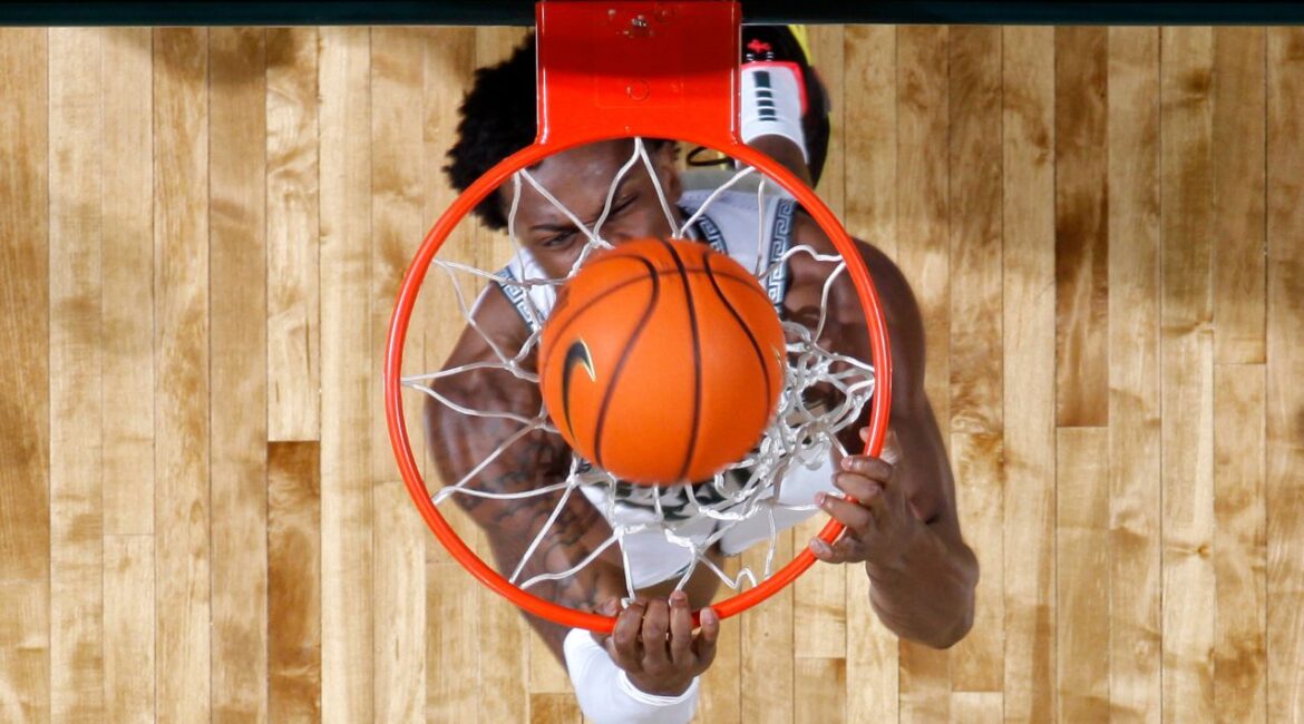 Michigan State forward Coen Carr throws down a reverse dunk during the first half of an NCAA college basketball game against Wisconsin, Sunday, March 2, 2025, in East Lansing, Mich. (AP/Al Goldis)
