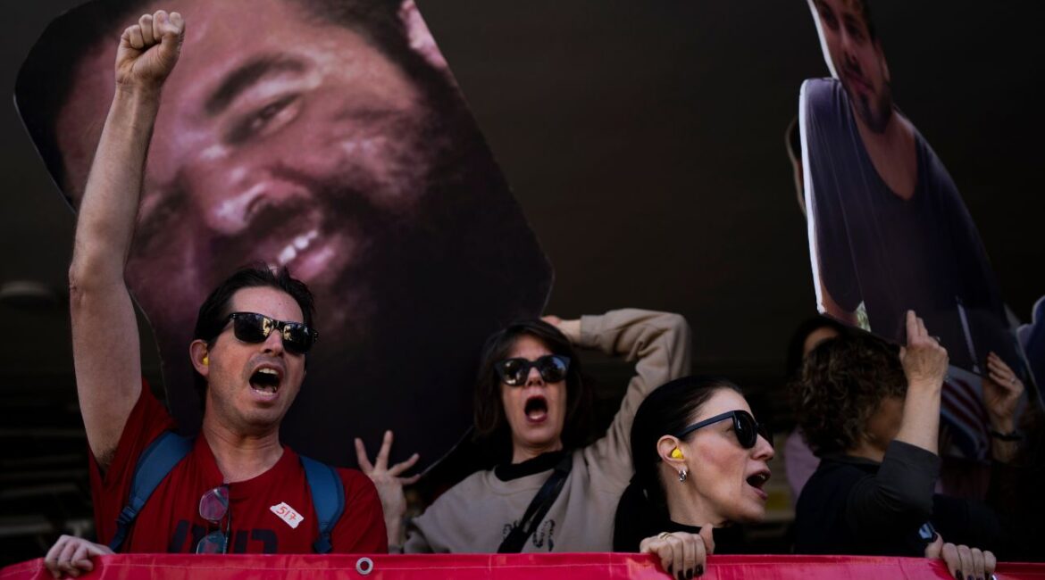 Demonstrators hold photos depicting the faces of Israeli hostages who are being held in the Gaza Strip, during a protest demanding their release from Hamas captivity, in Tel Aviv, Israel, Thursday, March 6, 2025. (AP/Oded Balilty)