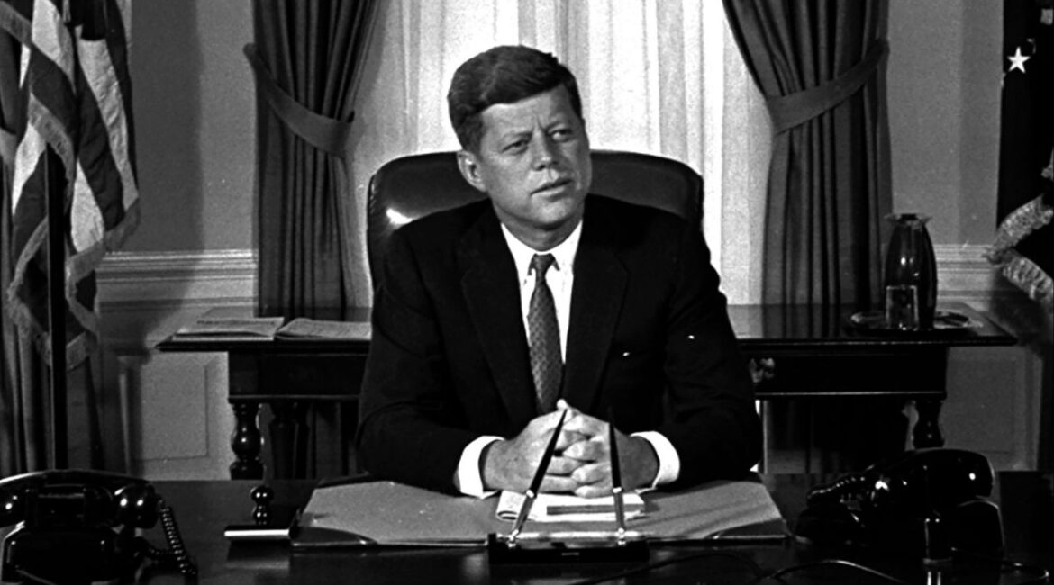 Newly-elected President Kennedy posed for first pictures at his White House desk, Jan. 21, 1961, before plunging into a busy round of conferences. (AP File)