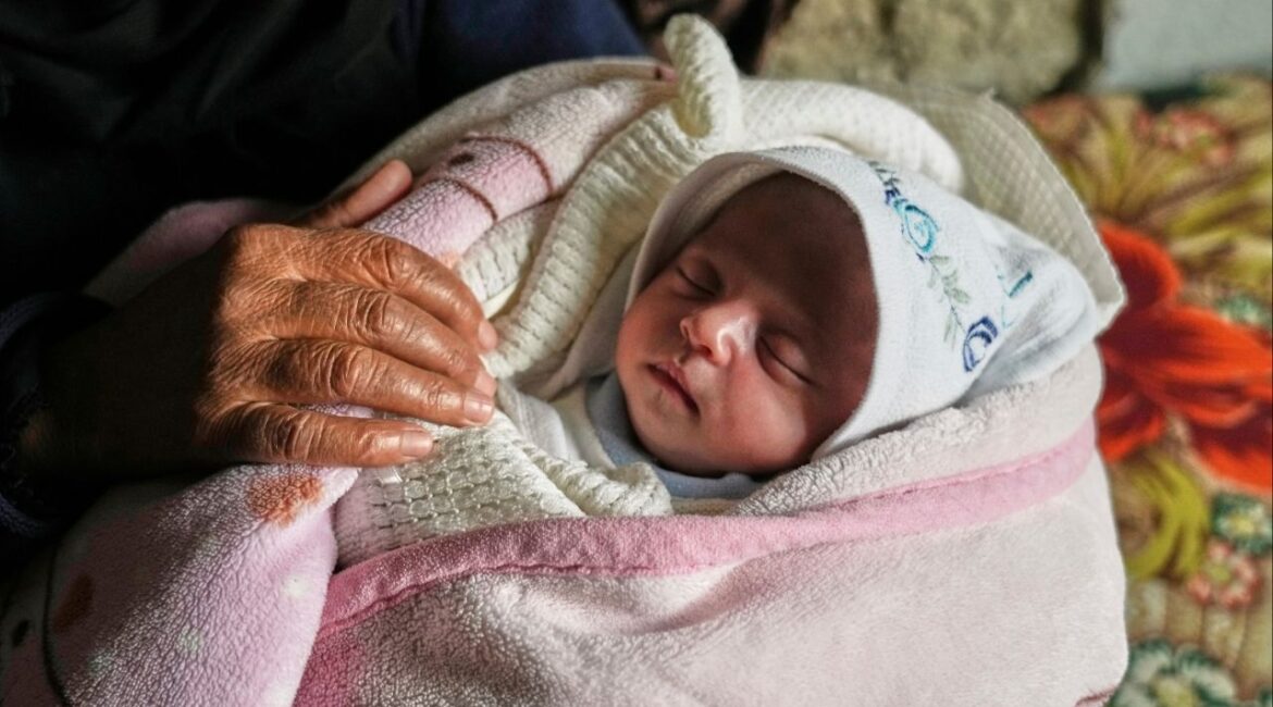 Ella Osama Abu Dagga, 25 days old, is held by her great-aunt Suad Abu Dagga after she was pulled from the rubble earlier following an Israeli army airstrike that killed her parents and brother in Khan Younis, southern Gaza Strip, Thursday, March 20, 2025. (AP/Abdel Kareem Hana)