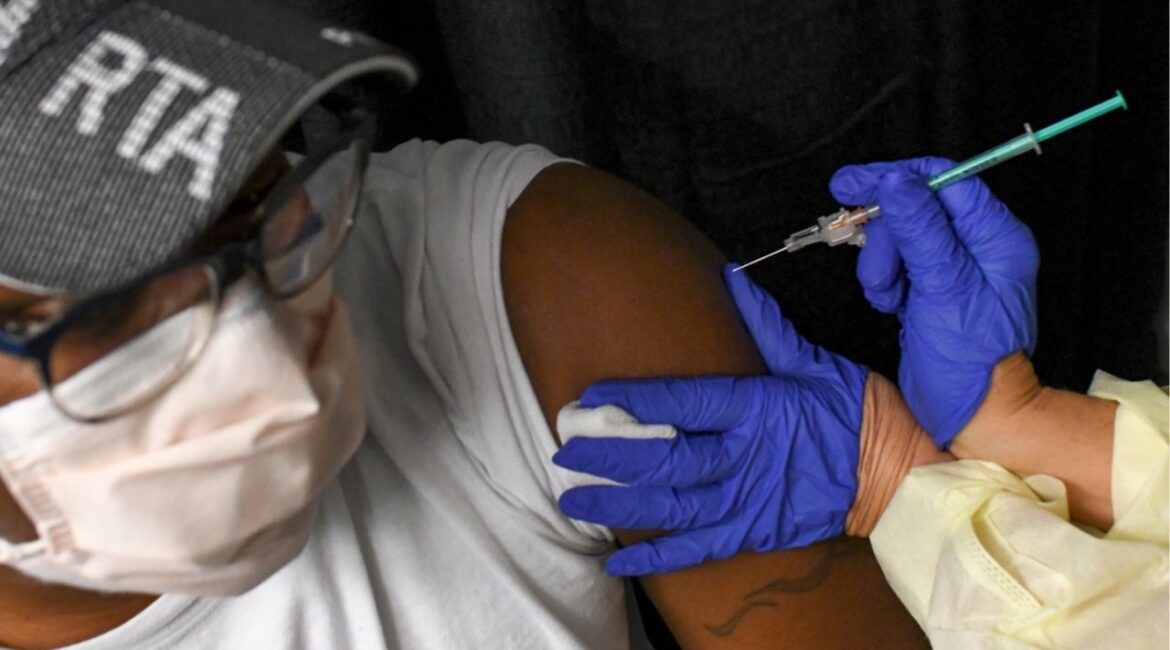 A COVID-19 vaccination is administered in Silver Spring, Md., Feb. 26, 2021. The Trump administration has canceled funding for dozens of studies seeking new vaccines and treatments for Covid-19 and other pathogens that may cause future pandemics. (Kenny Holston/The New York Times)