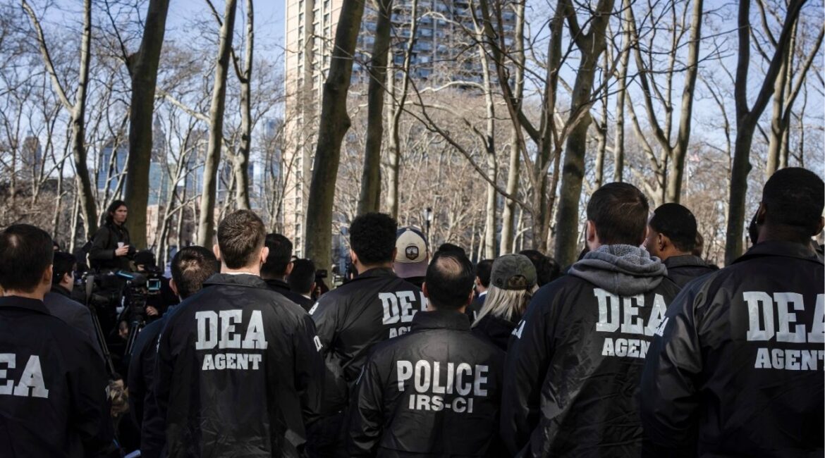 DEA officers stand at a press conference following the arraignment of two alleged Mexican cartel operatives at the Brooklyn Federal Court Building, in New York, on Feb. 28, 2025. The Trump administration is considering major changes in how the Justice Department operates, including by merging the Drug Enforcement Administration and the Bureau of Alcohol, Tobacco, Firearms and Explosives into one, according to an internal memo. (Dave Sanders/The New York Times)