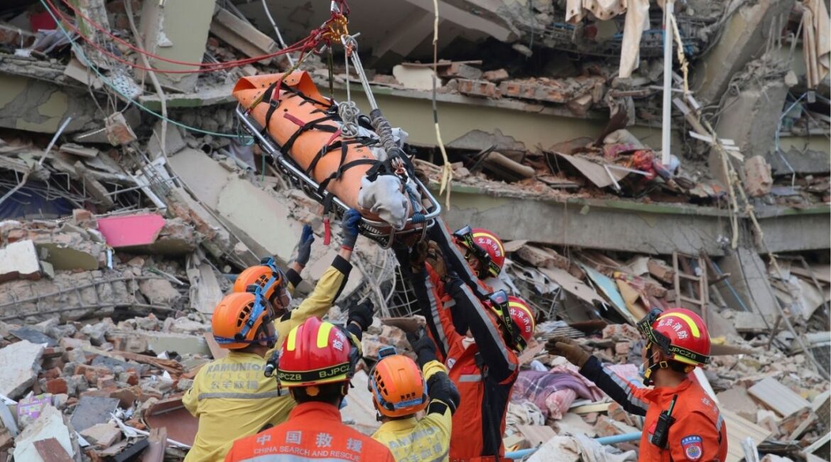 In this photo released by Xinhua News Agency, members of a China search and rescue team transfer a pregnant survivor from a collapsed building in the aftermath of an earthquake in Mandalay, Myanmar, Monday, March 31, 2025. (Myo Kyaw Soe/Xinhua via AP)