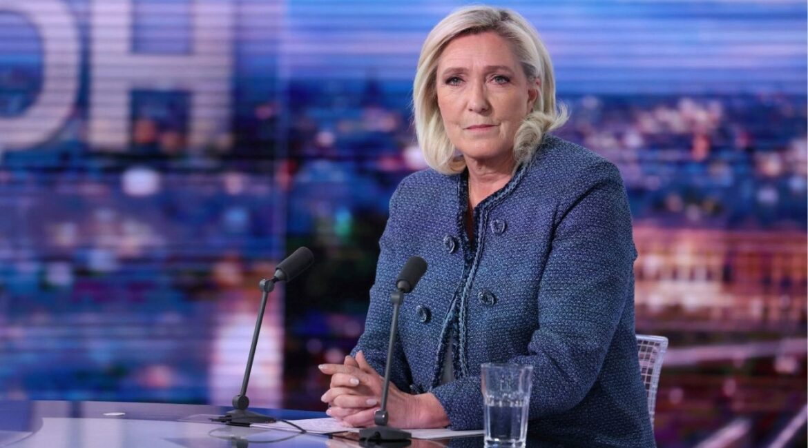 Far-right leader Marine Le Pen poses prior to an interview on the evening news broadcast of French TV channel TF1, after a French court convicted Marine Le Pen of embezzlement and barred her from seeking public office for five years, Monday, March 31, 2025, in Boulogne-Billancourt, outside Paris. (Thomas Samson, Pool via AP)