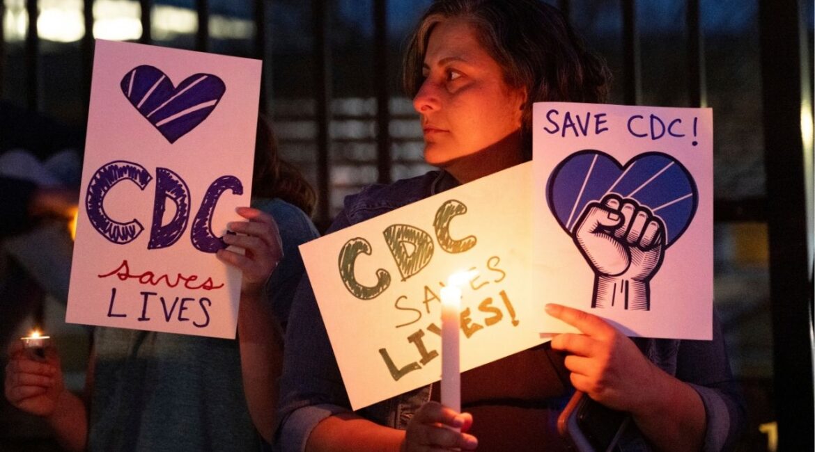 People gather for a candlelight vigil in support of the Centers for Disease Control and Prevention in front of its headquarters in Atlanta, Friday, March 28, 2025. (AP/Ben Gray)