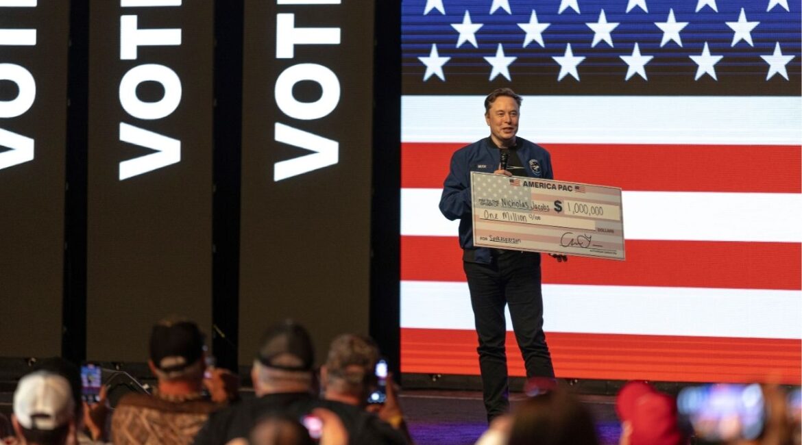 Elon Musk with a check for $1 million as he headlines a rally in support of conservative judicial candidate Brad Schimel in Green Bay, Wis., March 30, 2025. Elon Musk and groups tied to him have spent more than $25 million backing Schimel, the conservative candidate for the open court seat. (Jim Vondruska/The New York Times)