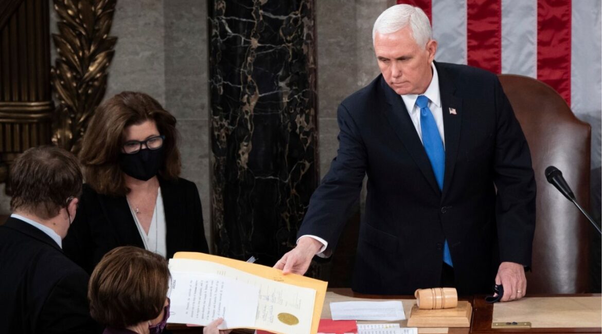 Vice President Mike Pence hands the electoral certificate from the state of Arizona to Sen. Amy Klobuchar, D-Minn., as he presides over a joint session of Congress as it convenes to count the Electoral College votes cast in November's election, at the Capitol in Washington, Jan. 6, 2021. (AP File)