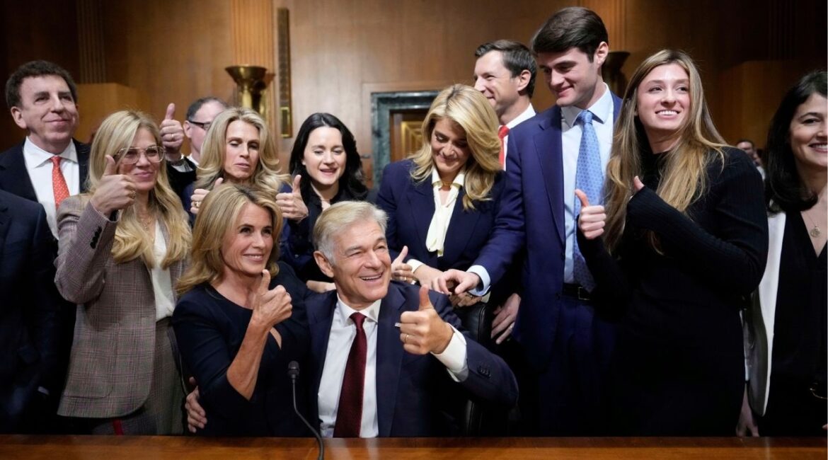 Dr. Mehmet Oz, President Donald Trump's pick to lead the Centers for Medicare and Medicaid Services, seated right, gives a thumbs-up alongside his wife Lisa Oz, seated left, with friends and family after he testified at his confirmation hearing before the Senate Finance Committee, on Capitol Hill in Washington, Friday, March 14, 2025. (AP/Ben Curtis)