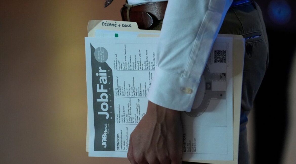 A person waits in a line for a prospective employer at a job fair, Thursday, Aug. 29, 2024, in Sunrise, Fla. (AP File)